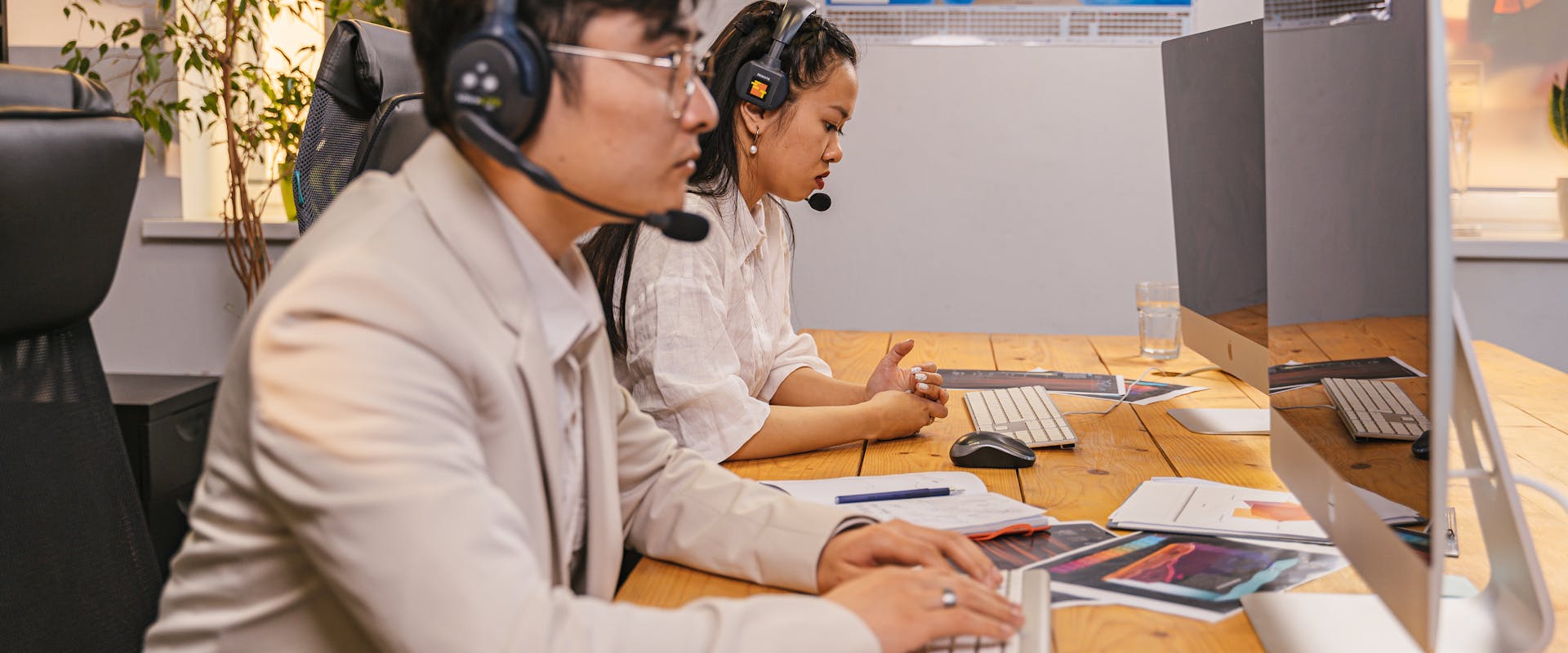 Support specialists helping customers remotely by phone and computer